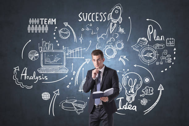 istock Businessman with notebook and business strategy sketch on blackboard 1331798800