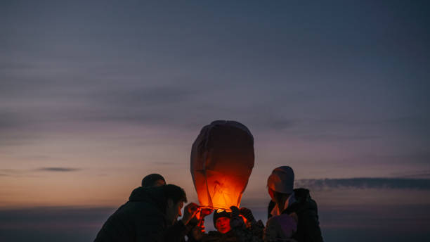 Family releasing burning sky lantern