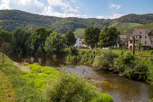 The river Ahr with the village of Dernau in the background. Stage finish on the red wine hiking trail through the Ahr Valley.