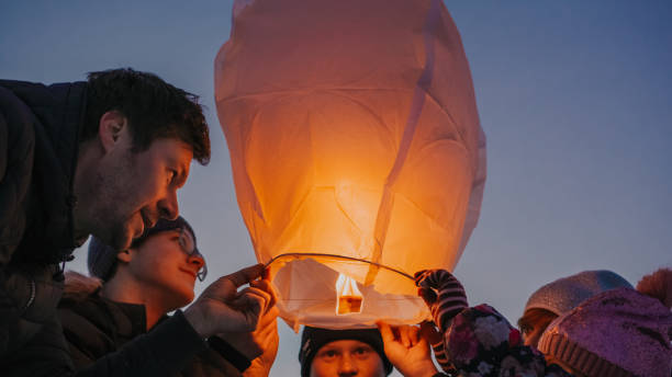 istock Family releasing burning sky lantern 1331799641