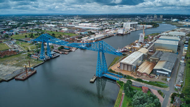 Middlesborough transporter bridge crossing River Tees, Middlesborough, North Yorkshire, England, Britain Blue painted Tees transporter bridge teesside northeast england stock pictures, royalty-free photos & images