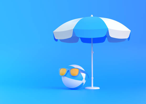 istock Beach ball under umbrella wearing sunglasses on blue background 1331800999