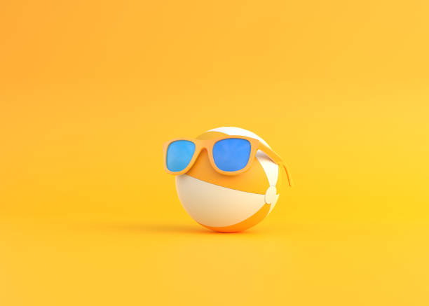 istock Beach ball wearing sunglasses on yellow background 1331801000