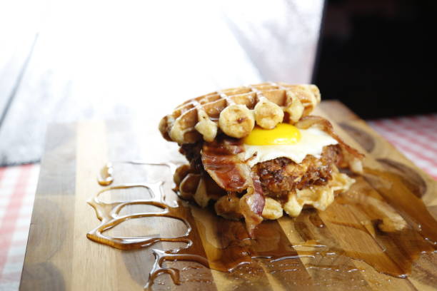 istock Chicken and Waffles. Southern Fried Chicken, Egg, and Bacon inside Waffles. Dripping with syrup 1331801053