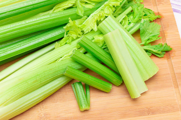 istock Fresh Celery Stem and Chopped Celery Sticks on Wooden Cutting Board 1331801454