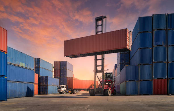 istock Engineers are overseeing the transportation of cargo with containers inside the warehouse. Container in export and import business and logistics. 1331804105