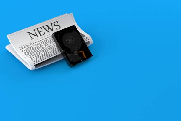 istock Hard drive with newspaper 1331805576