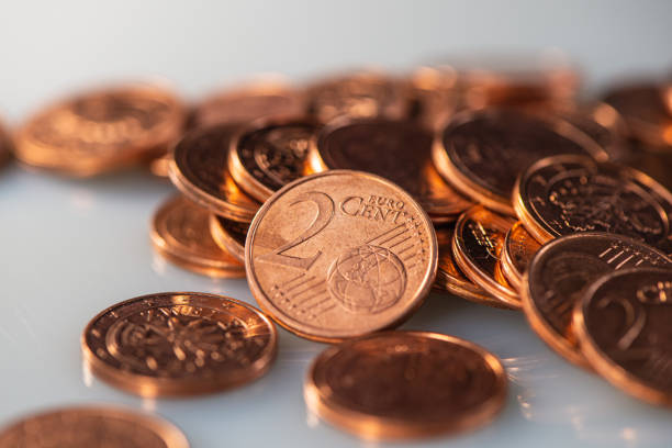 Two Euro Cent Coin Lies on the Coins, Close-Up. Business Concept.