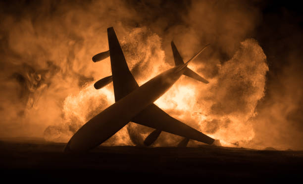 istock Air Crash. Burning falling plane. The plane crashed to the ground. Decorated with toy at dark fire background. Air accident concept. 1331811305