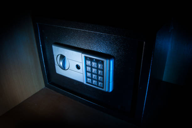istock Small modern safe on shelf in dark. Small safe box close up in low key light 1331811327