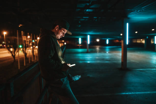 istock Man using mobile phone at parking lot 1331813903