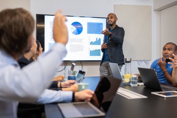 istock Businessman asking a question at a presentation 1331814212