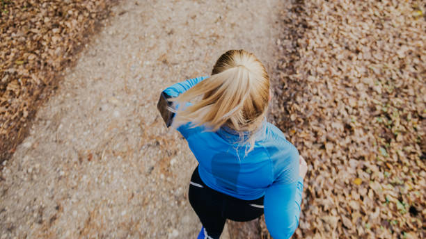 istock Athletic woman running in park 1331814317