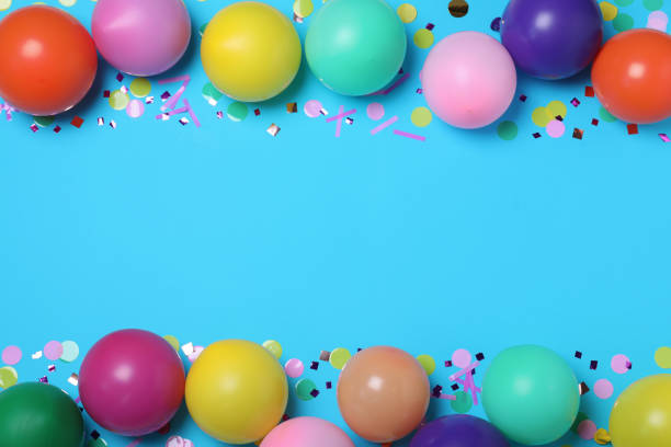 istock Many balloons and confetti on light blue background, flat lay with space for text. Birthday decor 1331815059