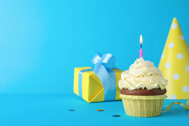 istock Delicious birthday cupcake with candle on light blue background, space for text 1331815171