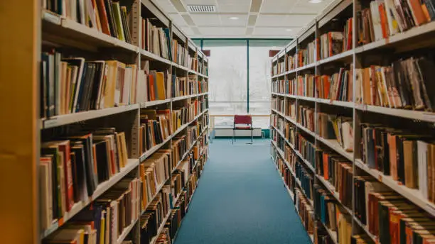 Photo of Books on shelves in library