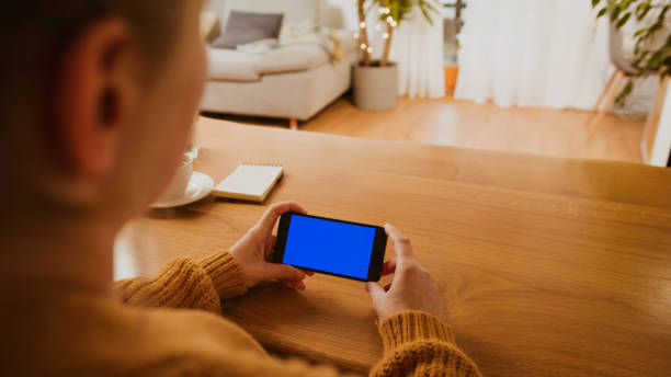 istock Woman using smartphone with chroma key screen 1331817635