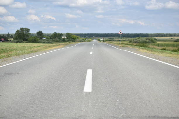 istock Asphalt expressway on a summer day with clouds 1331817728