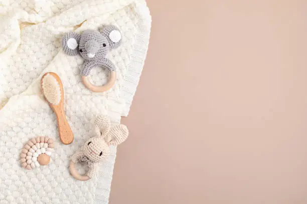 Eco fiendly organic baby rattle and teethers. Sustainable, developmental, sensory toys for newborns. Top view, flat lay, copy space