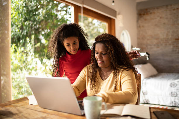 istock Mature woman using laptop working at home with daughter 1331819778