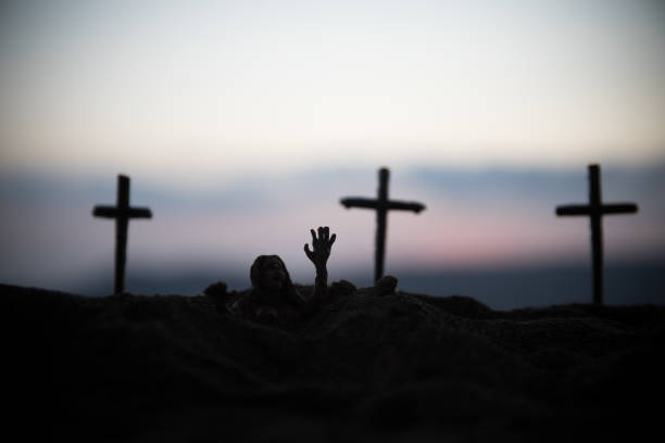 istock Silhouette some zombies on the cemetery walking around at sunset. Selective focus 1331820662