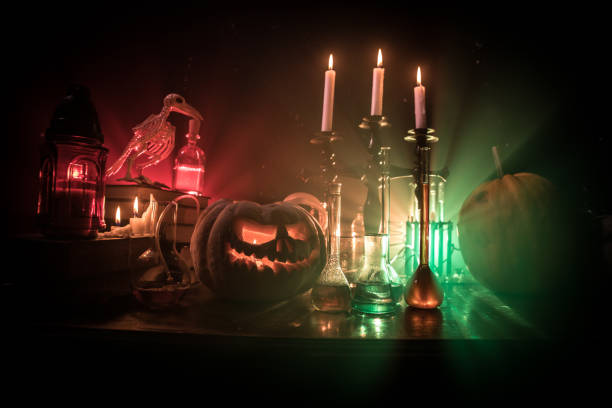 istock Halloween still-life background with different elements on dark toned foggy background. Selective focus 1331820805