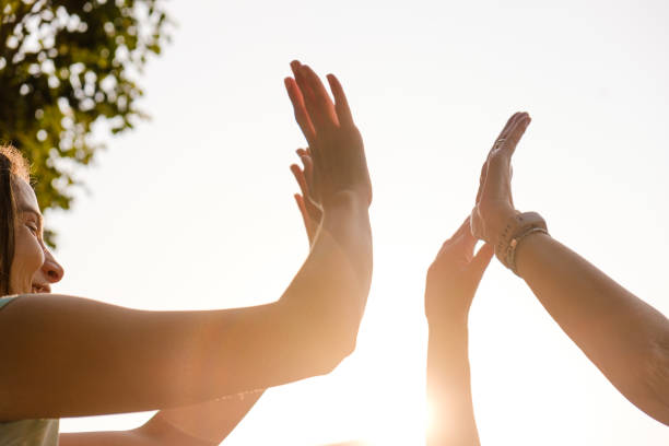 istock Senior and young woman clapping palms at sunset. 1331822124