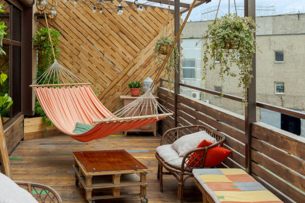 hammock hangs on wooden terrace - balcony imagens e fotografias de stock