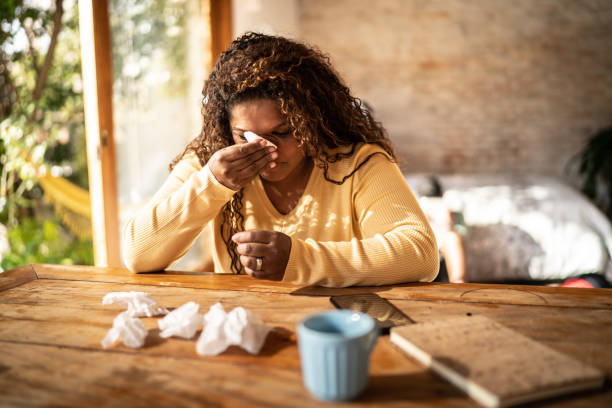 istock Sick mature woman blowing nose at home 1331824621