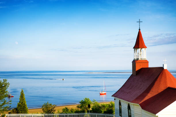 Church steeple overlooking the Saint-Lawrence gulf on a quiet Summer evening stock photo