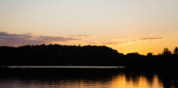Panoramic view of a Summer sunset over Kenogami lake in Quebec's Saguenay area