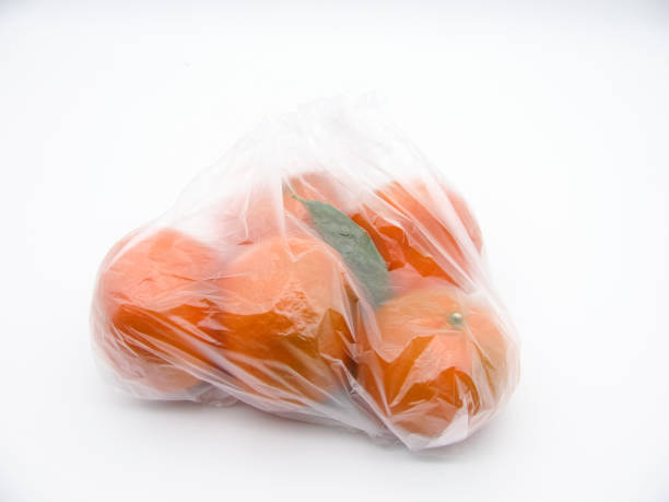 istock Orange fresh tangerines in a transparent bag on a white background. 1331831577