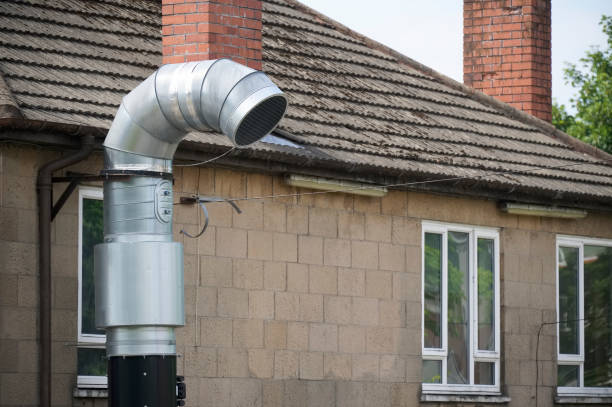 flue chimney fixed to building exterior wall stainless steel from exhaust boiler plant room - flue gas imagens e fotografias de stock