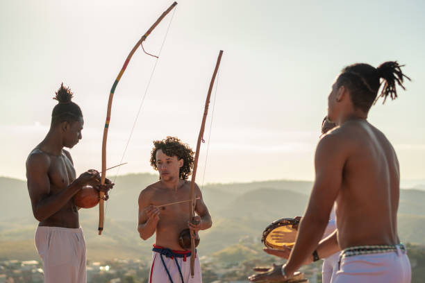istock Capoeira people playing berimbau and percussion instruments 1331832892