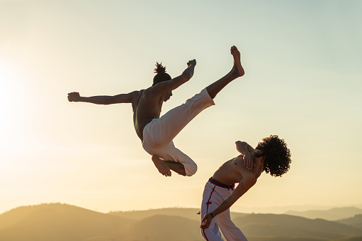 Capoeira luchador saltando patadas photo