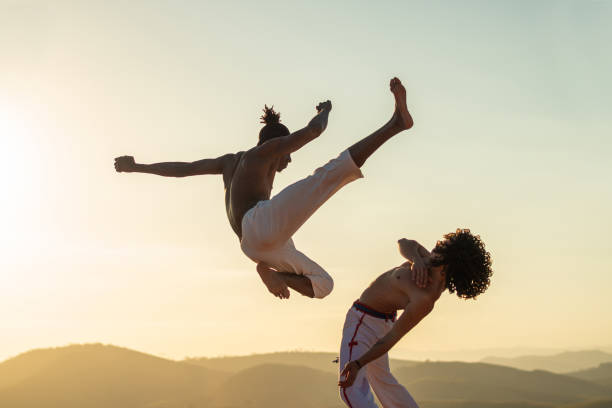 Capoeira fighter jumping kicking