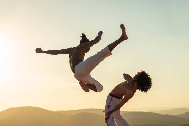 Capoeira fighter jumping kicking Capoeira, Brazilian Culture, Brazil, Tradition, Outdoor brazilian culture stock pictures, royalty-free photos & images