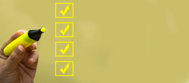 istock hand holding yellow felt pen and marking on checklist box. Checklist concept, copy space 1331833013