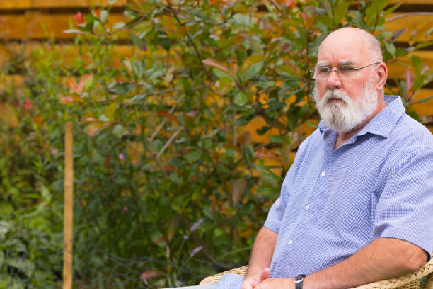 istock Elderly man sitting in his garden 1331833754