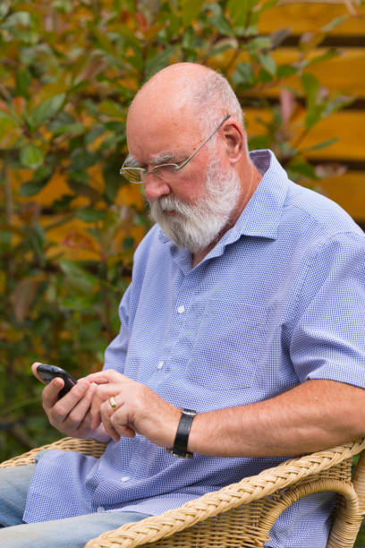 istock Elderly man texting in his garden 1331833922