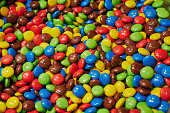 multicolored chocolate lentils background photo