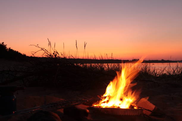 istock Beach Campfire on Lake. Red sky Superior at sunset as vacation concept 1331834697