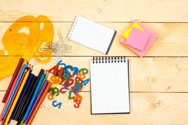 istock Back to school concept - colorful pencils and notebook, sticky note on wooden table 1331834781