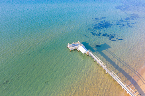 Aerial photograph captured at Sorrento, Victoria located on the Mornington Peninsula of a jetty on golden hour.