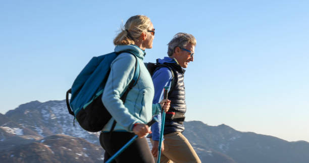 istock Mature couple hike along grassy mountain ridge 1331835717