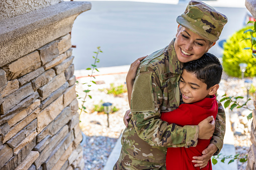 A mother in the Military returning home to greet her son at home.