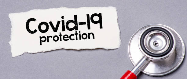 istock Covid-19 protection text on a small piece of paper. 1331838016