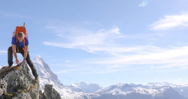 istock Mountaineer climbs up to mountain summit 1331838606