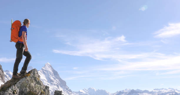 istock Mountaineer climbs up to mountain summit 1331838678