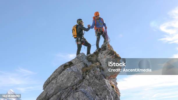 Mountaineers High Five On Mountain Summit Stock Photo - Download Image Now - High-Five, Mountain Peak, Mountain Climbing